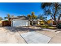 Charming single-story home featuring a well-manicured lawn, desert landscaping, and a two-car garage at 2201 S Evergreen Rd, Tempe, AZ 85282