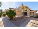 Attractive home showcasing a desert landscaped front yard with a mature palm tree and tiled roof at 2640 S Los Altos Dr, Chandler, AZ 85286