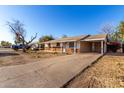 Cozy single-level home with a brick accent and attached carport on a sunny day at 2806 W Marshall Ave, Phoenix, AZ 85017