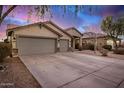 Expansive driveway leading to a well-maintained home with a three-car garage and desert landscaping at 29983 W Fairmount Ave, Buckeye, AZ 85396