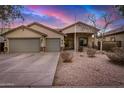 Attractive single-story home with a three-car garage, desert landscaping and a welcoming covered entry at 29983 W Fairmount Ave, Buckeye, AZ 85396