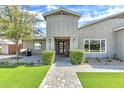 Welcoming front entrance features a modern door, neatly trimmed bushes and paver walkway at 3007 N 47Th St, Phoenix, AZ 85018