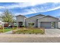 Charming home exterior with a well-manicured lawn, modern gray paint, and a wood fence at 3007 N 47Th St, Phoenix, AZ 85018