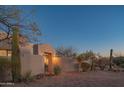 Charming stucco home with desert landscaping and well-lit entry at 30600 N Pima Rd # 19, Scottsdale, AZ 85266