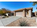 Charming home with desert landscaping, a tile roof, a two-car garage, and stone accents at 3650 W Denali Dr, Anthem, AZ 85086