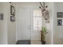 Bright entryway featuring tile flooring, front door with sidelight, and decor at 4541 N 129Th Dr, Litchfield Park, AZ 85340