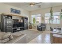 Spacious living room with tile flooring, large windows for natural light, and comfortable seating at 4541 N 129Th Dr, Litchfield Park, AZ 85340