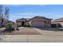 Single story home with low maintenance desert landscaping, a neutral palette and a private two-car garage at 4658 S Rufino Ln, Gold Canyon, AZ 85118