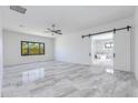 Large bedroom with modern barn door leading to bright ensuite bathroom at 5468 E Dove Valley Rd, Cave Creek, AZ 85331