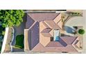 Bird's eye view of the red-tiled roof with an outdoor patio and turf area at 6014 W Bent Tree Dr, Phoenix, AZ 85083