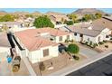 Charming single-story home with mature landscaping, neutral-tone stucco, red tile roof, and a paver driveway at 6014 W Bent Tree Dr, Phoenix, AZ 85083