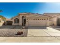 Charming single-story home featuring a well-manicured desert landscape, neutral stucco exterior, and a tile roof at 635 W Douglas Ave, Gilbert, AZ 85233