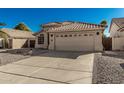 Charming single-story home featuring a well-manicured desert landscape, neutral stucco exterior, and a tile roof at 635 W Douglas Ave, Gilbert, AZ 85233