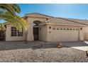 Charming single-story home featuring a well-manicured desert landscape, neutral stucco exterior, and a tile roof at 635 W Douglas Ave, Gilbert, AZ 85233