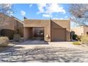 Front exterior showcasing attached garage, porte-cochere and neutral paint at 9221 E Whitethorn Cir, Scottsdale, AZ 85266