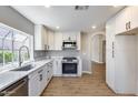 Bright kitchen with stainless steel appliances, white cabinets, and modern countertops for a sleek and functional space at 9513 E Hercules Dr, Sun Lakes, AZ 85248