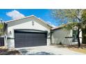 Charming home boasting a gray two-car garage and a well-manicured front lawn at 10030 W Illini St, Tolleson, AZ 85353