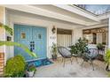 Inviting front porch with stylish seating and a decorative blue double-door entrance at 1047 E 9Th St, Mesa, AZ 85203