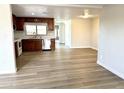 Open-concept living space connecting the kitchen and dining areas with laminate flooring at 1109 E Emerald Ave, Mesa, AZ 85204