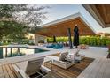 Backyard pool area featuring a covered outdoor kitchen, fireplace, and ample lounge seating at 11222 N 73Rd St, Scottsdale, AZ 85260