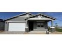 Charming single-story home with a gray stucco exterior, stone accents, and a two-car garage at 15744 W Beryl Ave, Waddell, AZ 85355