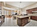 Gourmet kitchen with granite countertops, dark wood cabinets, and a view into the living room at 1738 W Yosemite Pl, Chandler, AZ 85248