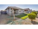 Private backyard with a small lawn and a covered patio, perfect for outdoor entertaining at 17580 W Country Club Ter, Surprise, AZ 85387