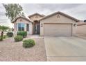 Inviting single-story home featuring desert landscaping and a two-car garage at 2477 E Valencia Dr, Casa Grande, AZ 85194