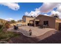 Spacious backyard patio with ample seating, hot tub, and desert landscaping perfect for entertaining at 24816 N Good Pasture Ln, Florence, AZ 85132