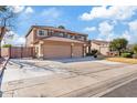 Two-story home with a three-car garage, tile roof and manicured lawn on a sunny day at 2535 E Saratoga St, Gilbert, AZ 85296