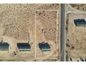 An aerial view showing the manufactured home with gray and white siding in its lot surrounded by a white line at 2735 S 357Th Dr, Tonopah, AZ 85354