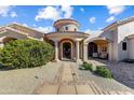 Charming walkway to front door with manicured bushes and unique architectural design at 27701 N Lucero Dr, Rio Verde, AZ 85263