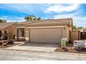 A neutral-colored single-story home with a two-car garage and desert landscaping at 30124 N Sunray Dr, San Tan Valley, AZ 85143