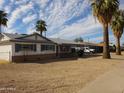 This single story home is situated in a neighborhood with desert landscaping and mature palm trees at 3345 W Laurel Ln, Phoenix, AZ 85029