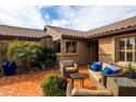 Inviting outdoor patio with comfortable seating, vibrant plants, and tiled flooring perfect for relaxing and entertaining at 3648 N 162Nd Ave, Goodyear, AZ 85395