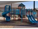 Neighborhood playground featuring colorful play structures, shade, and seating, perfect for Gathering recreation at 3720 S 87Th Dr, Tolleson, AZ 85353