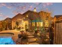 Outdoor living space with a pool, dining area, lush greenery, and cozy seating areas at 3767 W Desert Creek Ln, Phoenix, AZ 85086