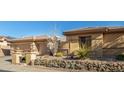 Charming single-story home featuring a desert landscape, a stone facade, and a two-car garage at 42043 N Bradon Way, Phoenix, AZ 85086