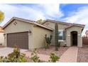 Beautiful single-story home with desert landscaping leading to the front door at 42577 W Rosalia Dr, Maricopa, AZ 85138