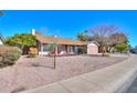 Single-story home features desert landscaping, a fenced front patio and an attached two-car garage at 4506 E Arapahoe St, Phoenix, AZ 85044