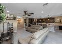 Open-concept living space with modern furnishings and seamless flow to kitchen area at 4588 W Suncup Dr, San Tan Valley, AZ 85144