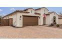 Beautful single story with brick paved drive, two car garage and desert landscape at 4887 N 184Th Ln, Goodyear, AZ 85395