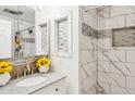 Modern bathroom featuring white marble-like tile in the shower with a glass door and granite countertops at 50880 W Val Vista Rd, Maricopa, AZ 85139