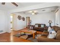 Cozy living room with wood floors, a neutral color scheme, ceiling fans, and comfortable furniture at 50880 W Val Vista Rd, Maricopa, AZ 85139