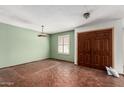 Empty living room featuring Saltillo tile floors and a large window at 614 W Mcnair St, Chandler, AZ 85225