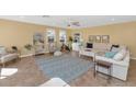 Bright living room with large windows, plush seating, and tile flooring, ideal for relaxation at 6420 E Gary Rd, Scottsdale, AZ 85254