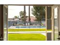 View of the pool area, with a fence, from inside of the home at 6834 E 4Th St # 6, Scottsdale, AZ 85251