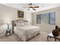 Comfortable bedroom with ceiling fan, large window and neutral paint at 705 W Queen Creek Rd # 2006, Chandler, AZ 85248