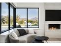 Stylish living room with a corner window offering views of the pool and mountain landscape at 8822 E Chino Dr, Scottsdale, AZ 85255