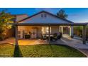 Large covered patio with outdoor seating and dining area, ideal for relaxing and enjoying backyard activities at 10594 E Wallflower Ln, Florence, AZ 85132